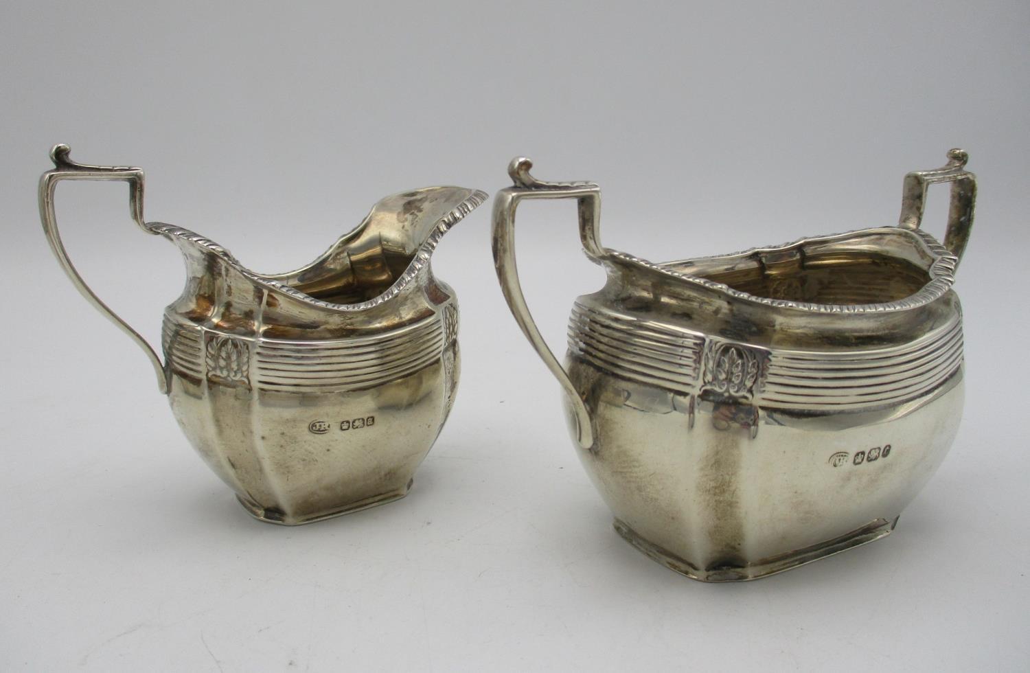 A late Victorian silver three piece tea set by John Round & Son, Sheffield 1895, retailed by Edwards - Image 4 of 4