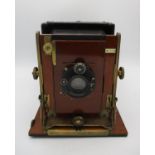 A Compur Tropical cased folding camera by Houghtons Ltd, London, in teak wood with brass fittings,