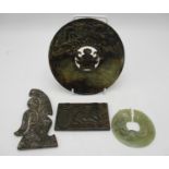A group of four Chinese jade carvings, to include a large circular disc carved with various mythical