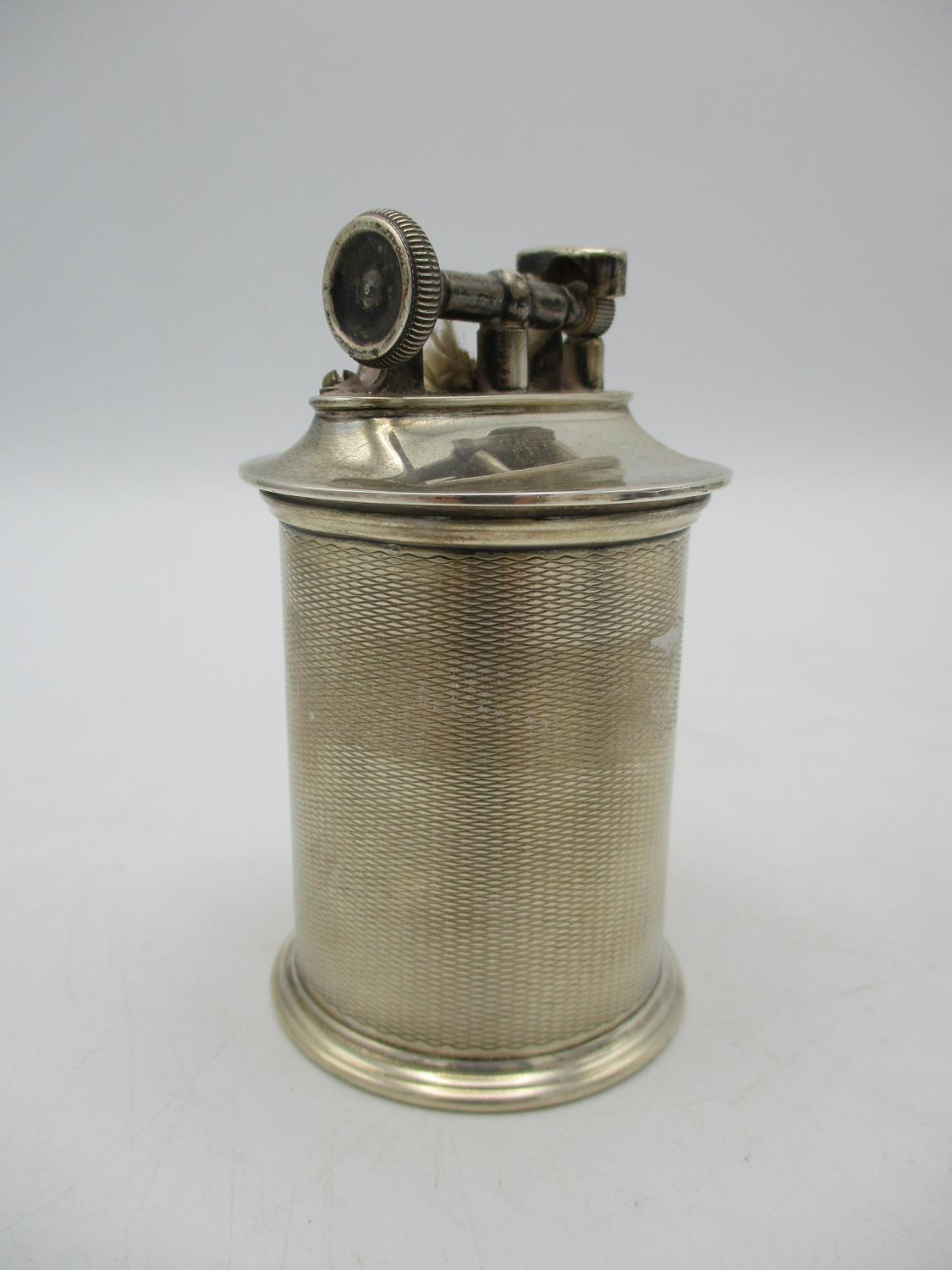 A George V silver table lighter by The Goldsmith and Silversmith Company Ltd, with cylindrical