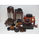 A collection of Chinese hardwood stands and bases, of various shapes and sizes.