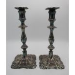 A pair of Victorian silver candlesticks by Henry Wilkinson, Sheffield 1894, designed with knapped