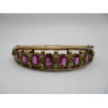 An Edwardian 9ct gold bracelet, Chester 1908 with a double wire frame set with seven amethysts and