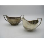 A matched pair of Edwardian silver sugar bowl and cream jug, both by Daniel George Colling,