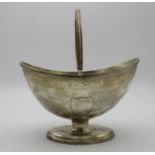 A George III silver swing handled sugar basket by Henry Chawner, London 1791, boat shaped with