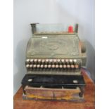 A National Cash Register Co brass till with floral spandrel panels, the hinged front enclosing dials