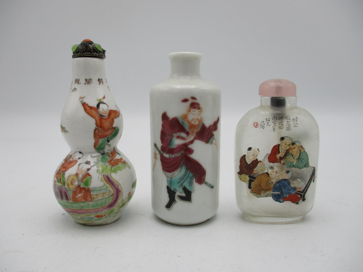 A small collection of three Chinese scent bottles, to include a rouleau model with applied enamels