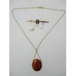 A Victorian agate pendant with 9ct gold chain, together with a cabochon tigers eye brooch set on