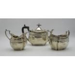 A late Victorian silver three piece tea set by John Round & Son, Sheffield 1895, retailed by Edwards