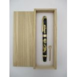 A Japanese Maki-e style fountain pen, elaborately decorated with a lacquer design of Autumnal