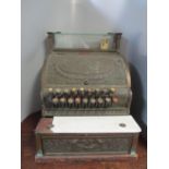 A National Cash Register Co brass till with wreath and scrolled foliage ornament, three glazed glass