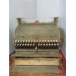 A National Cash Register Co brass till with wreath and scrolled foliage ornament, a hinged front,