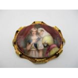 A Continental style hand painted porcelain brooch, of oval form depicting two women, one dressed