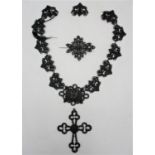 A 19th century Berlin iron choker necklace with cross pendant and pin, designed with pierced foliate