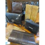 A vintage reptile stationary folder, a snakeskin clutch bag and two others, together with