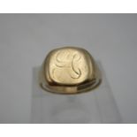 A gold coloured metal signet ring with worn initials, 6.2g, size R