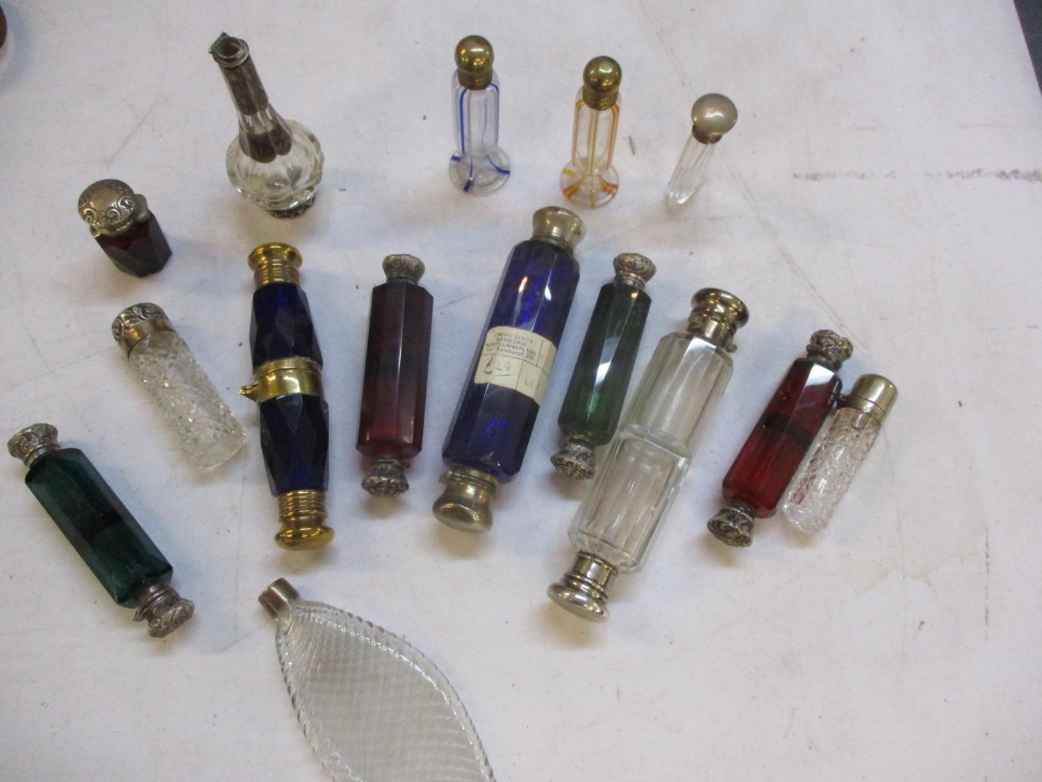 A quantity of Victorian and later scent bottles to include double ended and silver topped bottles,