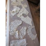 A Victorian cream lace machine made rectangular tablecloth having a hand sewn border of flora and