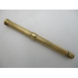 A 9ct gold Sampson Mordan retracting pencil, with central sliding ring, 9 cm long (shut)