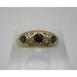 A 9ct gold ring set with three sapphires and four diamonds, 3.2g, size N