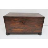 A Victorian rosewood tea caddy of rectangular form with cast bronze ring handles either side,