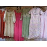 A collection of six 1970s ladies evening gowns to include a dark pink chiffon, long sleeved and full