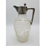 A late 19th century German silver mounted claret jug, the cut glass body of ovoid shape with