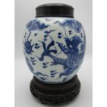 A Chinese Kangxi blue and white porcelain ginger jar, with dragon and pearl design, turned wooden