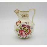 An early 19th century Staffordshire miniature jug, with hand painted floral sprays ad gilt