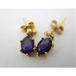 A pair of 18ct gold earrings, each set with three diamonds and an amethyst pendant, 2.3g in a