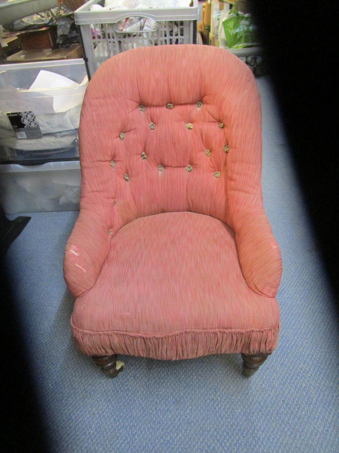 A Victorian mahogany child's upholstered chair, turned front legs on ceramic castors, button back