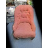 A Victorian mahogany child's upholstered chair, turned front legs on ceramic castors, button back