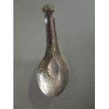 A Chinese silver rice spoon with floral engraved decoration and stylized finial, signed verso,