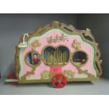 A painted wooden musical child's toy ornament in the form of a carnival organ with a key wound