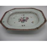 A late 18th century Chinese meat dish decorated with flowers to the centre, a band of flowers and