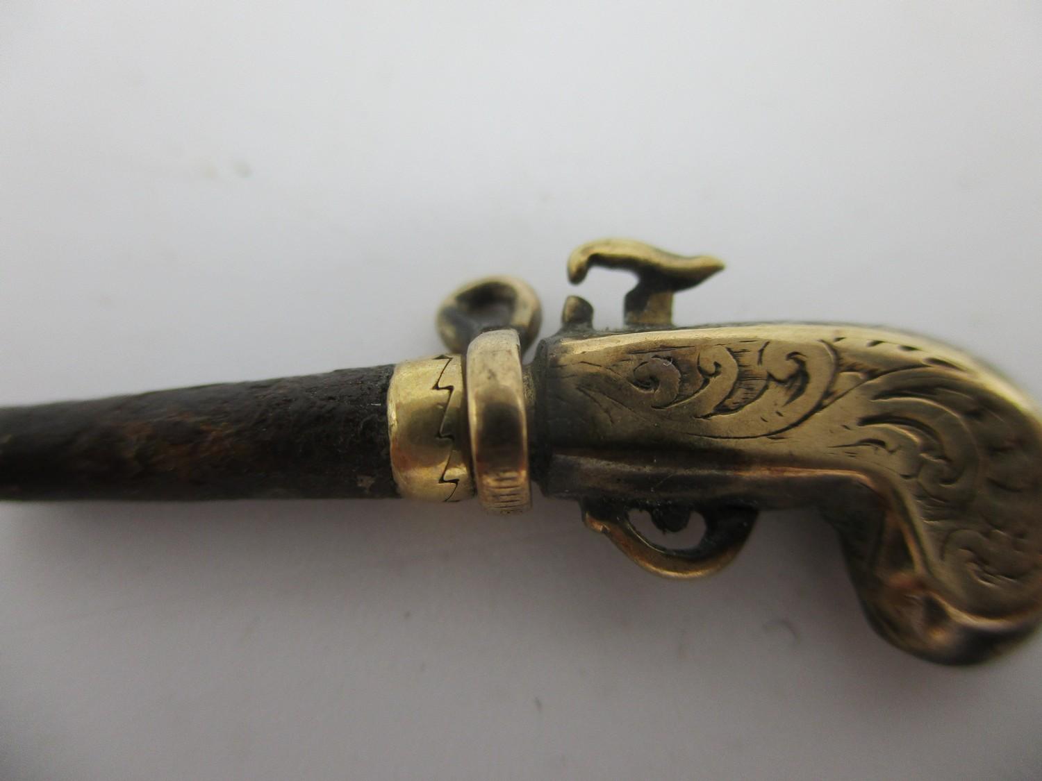 A gold coloured metal and steel watch key fashioned as a pistol with a ratchet mechanism Location: - Image 3 of 3