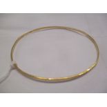 A gold coloured metal bangle