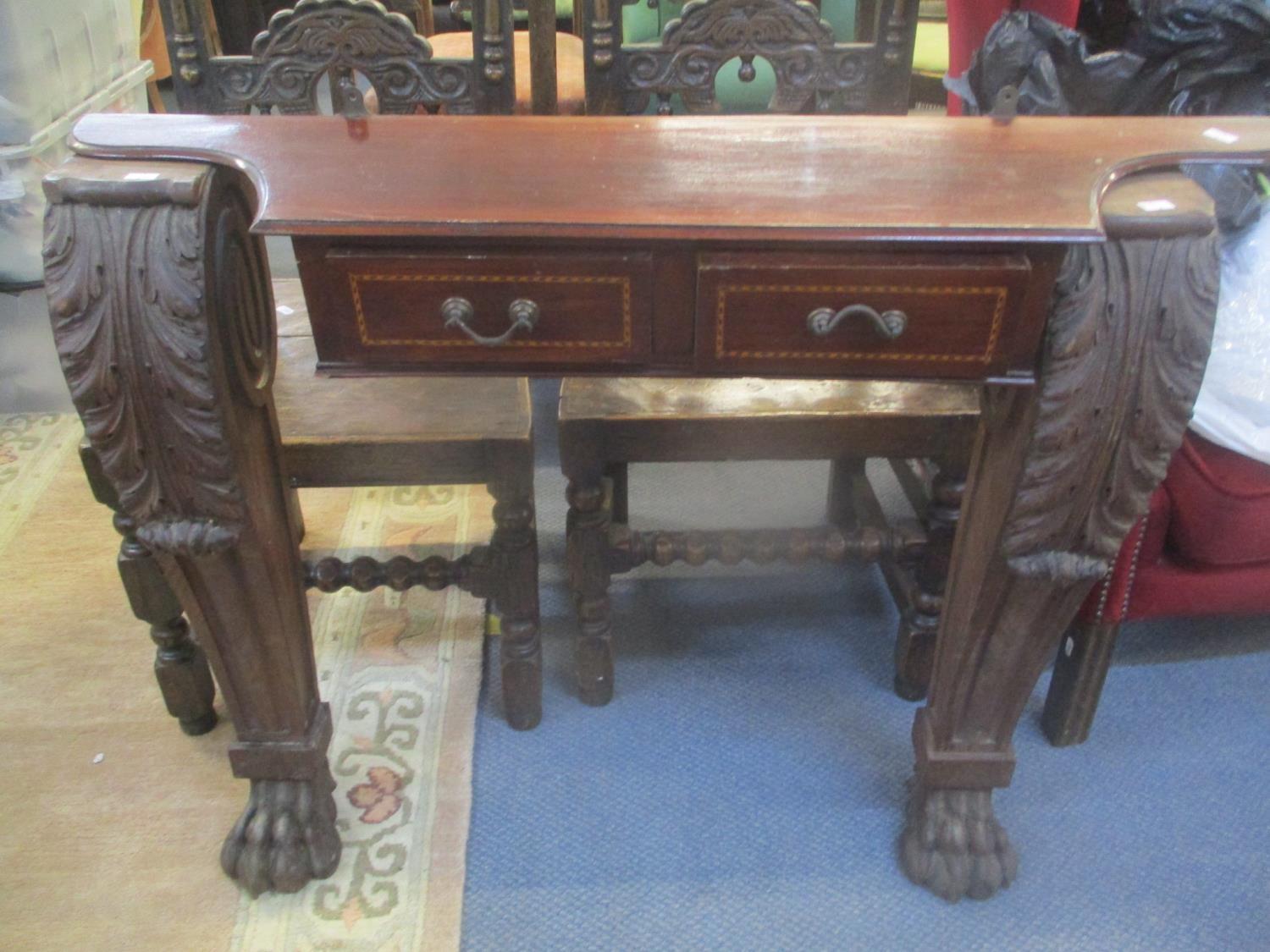A pair of table legs having acanthus leaf decoration and lion paw feet, together with a set of