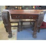 A pair of table legs having acanthus leaf decoration and lion paw feet, together with a set of