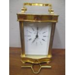 A modern brass cased carriage clock the dial inscribed LEpee on turned feet