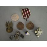 A group of Polish medals shouldered badges and others, along with a 1951 crown