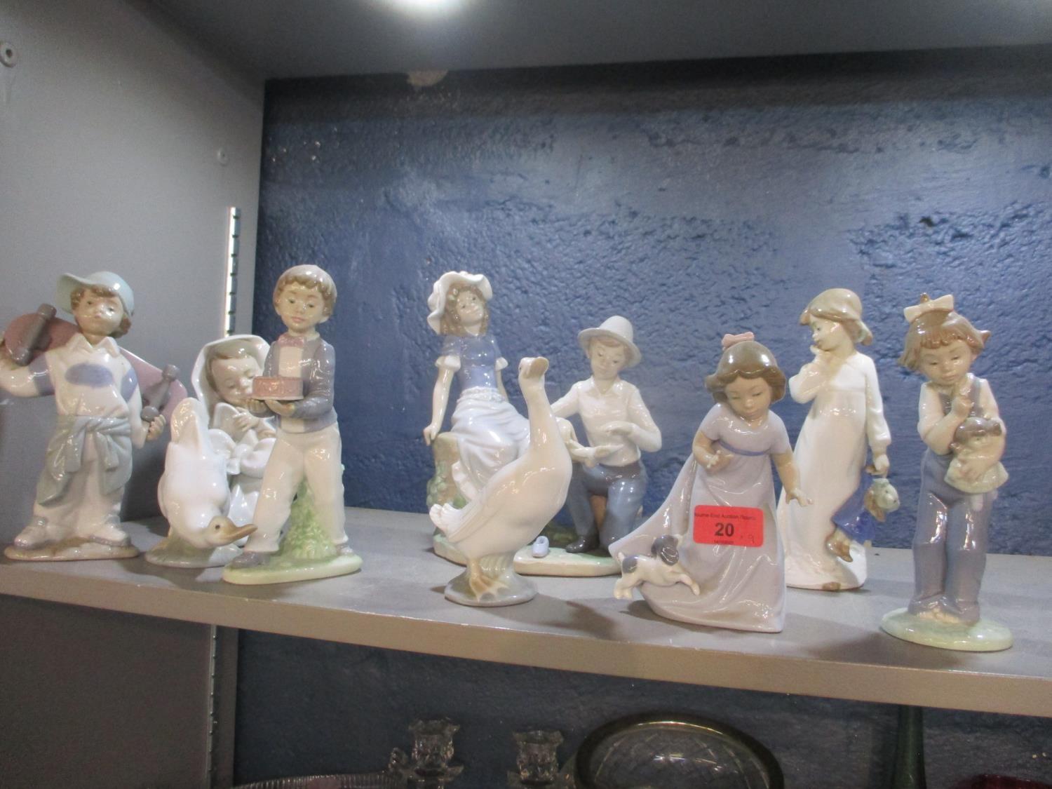 A collection of nine Nao porcelain figures, to include examples modelled as children, maidens and