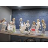 A collection of nine Nao porcelain figures, to include examples modelled as children, maidens and