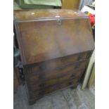 An early 20th century walnut bureau having a fall flap above four drawers and bracket shaped feet