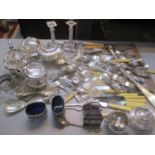 A large mixed lot of silver plate to include a pair of candlesticks, salad servers, fish knives