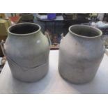 Two aluminium milk churns with swing handles