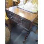 A 19th century mahogany work table with fall flaps, two drawers and a slide minus the wall, on