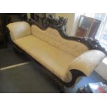 A reproduction 19th century style mahogany double end sofa having a carved eagle to the centre