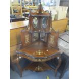 An Edwardian walnut Sheraton revival corner stand having a raised mirrored back and urn and floral
