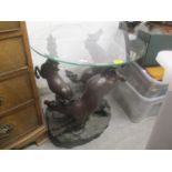 A bronzed finished resin occasional table in the form of three horses with a circular glass top